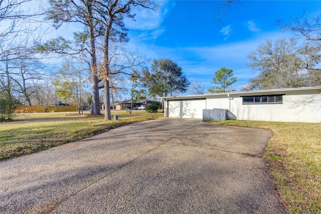 view of outdoor structure with driveway and a garage