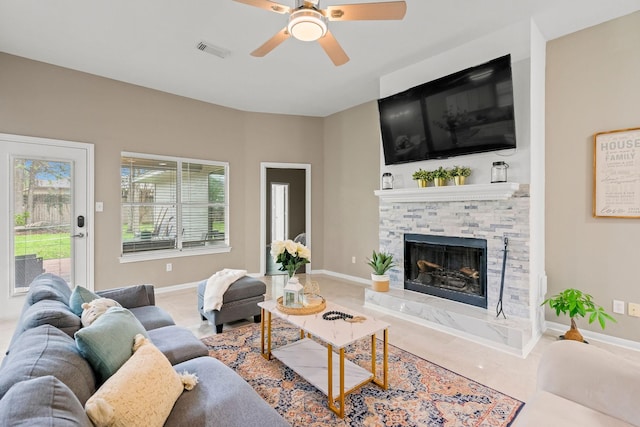 6719 Woodland Oaks, Magnolia, TX 77354 - living room featuring ceiling fan, healthy amount of natural light, a fireplace, and baseboards