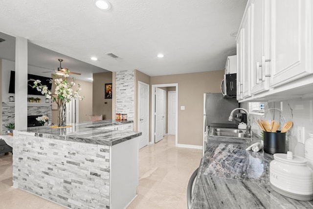 6719 Woodland Oaks, Magnolia, TX 77354 - kitchen featuring stainless steel microwave, a sink, ceiling fan, white cabinetry, and recessed lighting