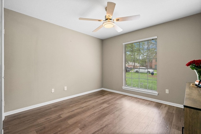 6719 Woodland Oaks, Magnolia, TX 77354 - spare room featuring baseboards, dark wood-style floors, and ceiling fan