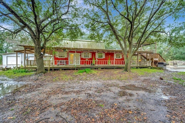 7027 Iowa Colony Blvd, Rosharon, TX 77583 - view of front of property with metal roof, a deck, and a garage