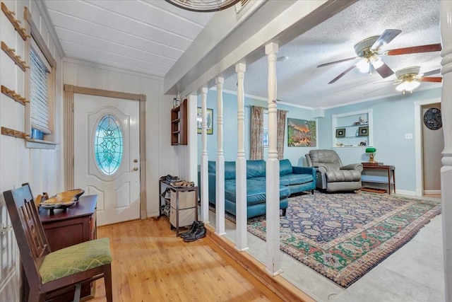 7027 Iowa Colony Blvd, Rosharon, TX 77583 - entrance foyer featuring ceiling fan, wood finished floors, baseboards, and decorative columns