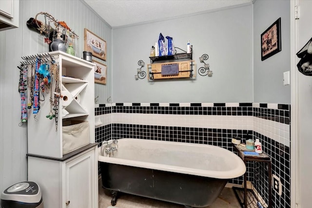 7027 Iowa Colony Blvd, Rosharon, TX 77583 - full bathroom with a soaking tub, a textured ceiling, and tile walls