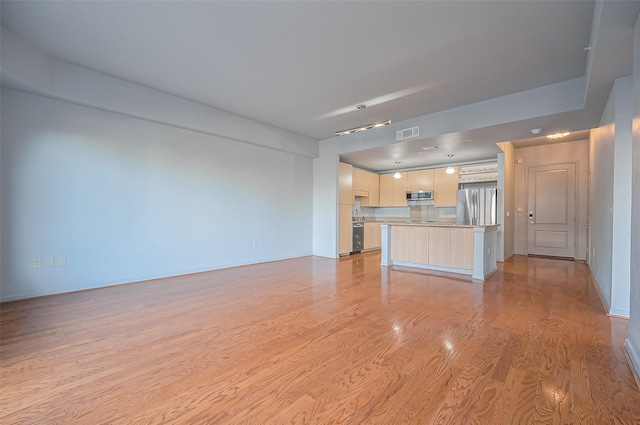 unfurnished living room with light wood finished floors