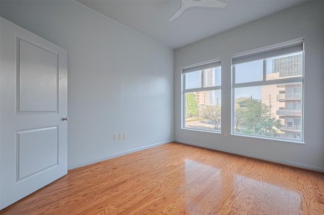 unfurnished room featuring wood finished floors and ceiling fan
