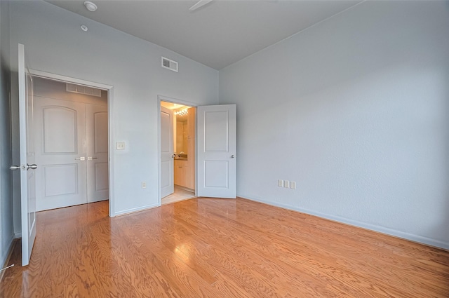 unfurnished bedroom featuring light wood finished floors and baseboards