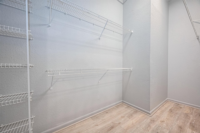 spacious closet with wood finished floors