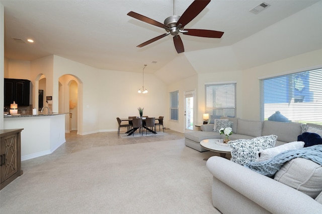 15623 Lavender Bay Ln, Cypress, TX 77429 - living area featuring arched walkways, light carpet, ceiling fan, lofted ceiling, and a chandelier