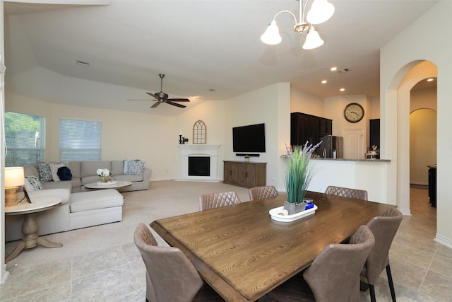 15623 Lavender Bay Ln, Cypress, TX 77429 - dining area with arched walkways, ceiling fan, a chandelier, a fireplace, and lofted ceiling