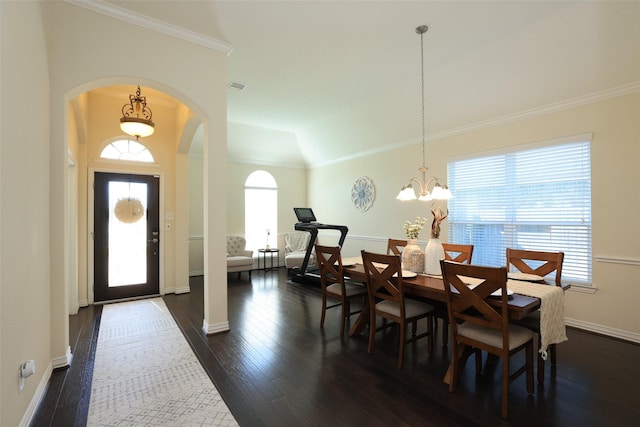 15623 Lavender Bay Ln, Cypress, TX 77429 - dining room featuring arched walkways, a chandelier, healthy amount of natural light, dark wood finished floors, and crown molding