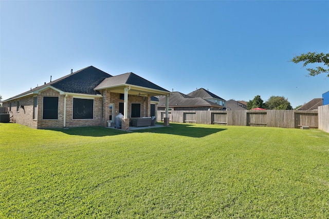 15623 Lavender Bay Ln, Cypress, TX 77429 - rear view of house featuring brick siding, central air condition unit, and a covered hot tub