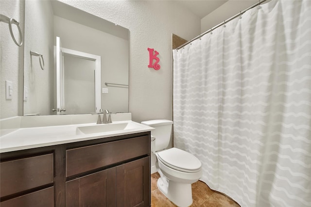 16711 Ramsay Cascades Dr, Humble, TX 77346 - bathroom featuring toilet, vanity, and a textured wall