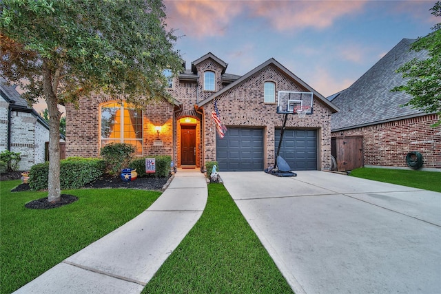 16711 Ramsay Cascades Dr, Humble, TX 77346 - view of front of home with brick siding, a yard, and driveway