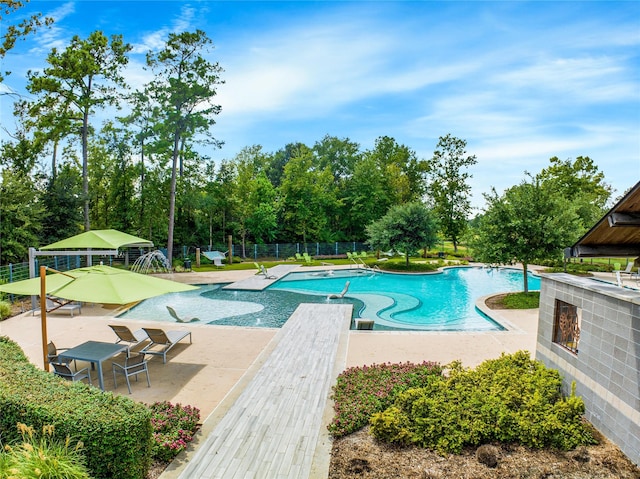 16711 Ramsay Cascades Dr, Humble, TX 77346 - community pool featuring a patio area and view of wooded area