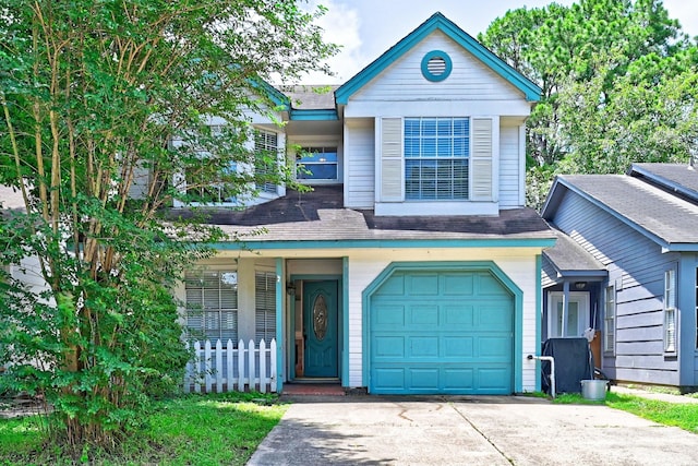 4319 Conward Dr, Houston, TX 77066 - view of front of home featuring an attached garage, concrete driveway, a porch, and roof with shingles