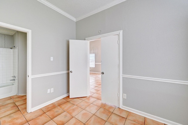 4319 Conward Dr, Houston, TX 77066 - unfurnished bedroom with light tile patterned flooring, ornamental molding, a textured ceiling, and ensuite bath