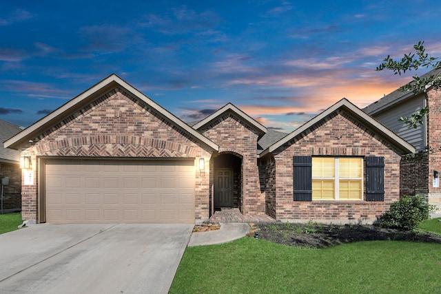 4827 San Gregorio Ln, Katy, TX 77493 - french country style house featuring concrete driveway, brick siding, a garage, and a lawn