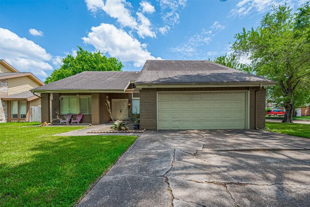 10315 Sun City Ct, Houston, TX 77099 - view of front of home featuring brick siding, a front lawn, an attached garage, driveway, and a shingled roof
