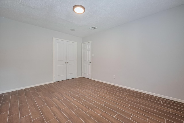 10315 Sun City Ct, Houston, TX 77099 - spare room featuring wood finished floors, baseboards, and a textured ceiling