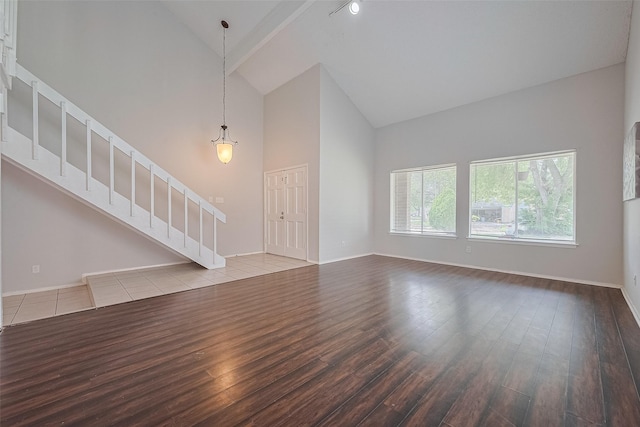 10315 Sun City Ct, Houston, TX 77099 - unfurnished living room with high vaulted ceiling, wood finished floors, stairway, and baseboards