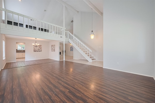 10315 Sun City Ct, Houston, TX 77099 - unfurnished living room featuring stairway, wood finished floors, a chandelier, beamed ceiling, and high vaulted ceiling