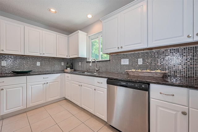 10315 Sun City Ct, Houston, TX 77099 - kitchen with dishwasher, a sink, light tile patterned floors, white cabinets, and backsplash