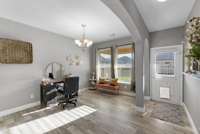 8315 Egret Bay Cir, Baytown, TX 77523 - office area with light wood-style flooring, a chandelier, baseboards, and arched walkways