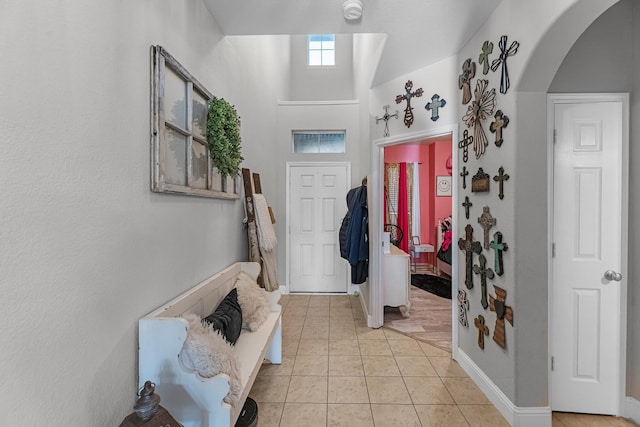 8315 Egret Bay Cir, Baytown, TX 77523 - entrance foyer with arched walkways, light tile patterned flooring, and baseboards