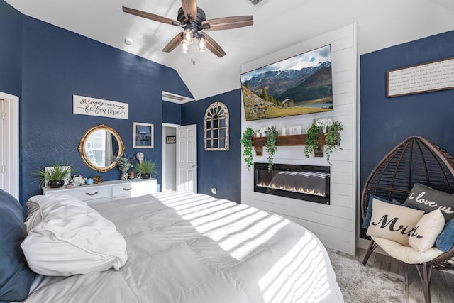 8315 Egret Bay Cir, Baytown, TX 77523 - bedroom with a glass covered fireplace, vaulted ceiling, and a ceiling fan