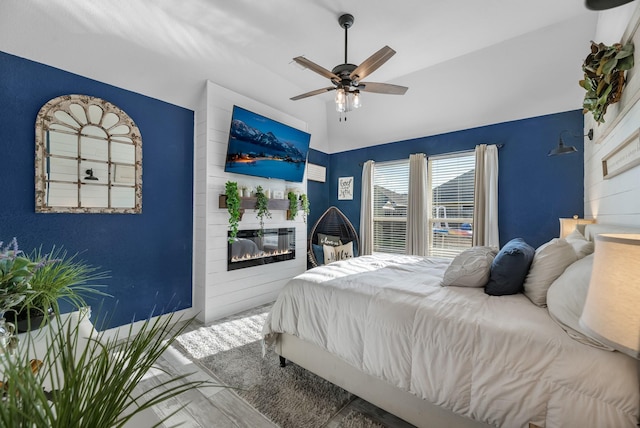 8315 Egret Bay Cir, Baytown, TX 77523 - bedroom featuring vaulted ceiling, a fireplace, ceiling fan, and wood finished floors