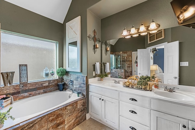 8315 Egret Bay Cir, Baytown, TX 77523 - bathroom featuring a shower stall, a bath, double vanity, tile patterned flooring, and lofted ceiling