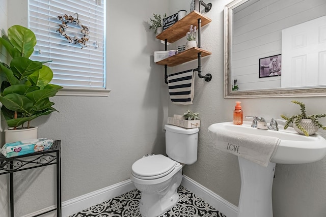 8315 Egret Bay Cir, Baytown, TX 77523 - bathroom featuring toilet, baseboards, and tile patterned floors