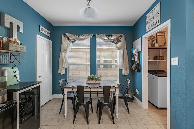 8315 Egret Bay Cir, Baytown, TX 77523 - dining space with independent washer and dryer, light tile patterned floors, baseboards, and wine cooler