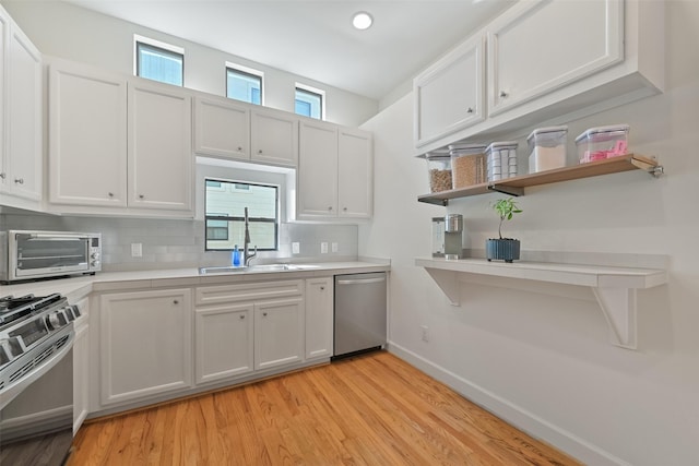 8715 Meadowcroft Dr Unit 1002, Houston, TX 77063 - kitchen with dishwasher, range with gas cooktop, light countertops, backsplash, and baseboards