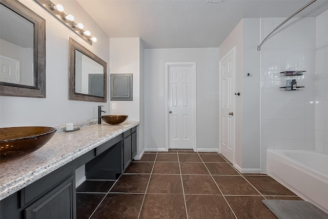 22627 Williamschase Dr, Katy, TX 77449 - full bathroom with tile patterned floors, baseboards, double vanity, and shower / tub combination
