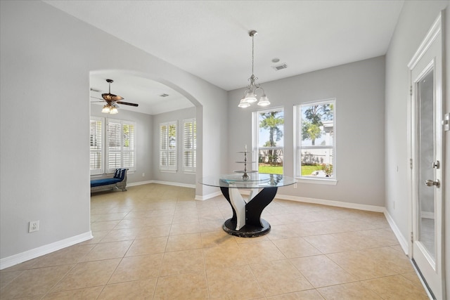 11127 Salento Ct, Richmond, TX 77406 - dining room featuring light tile patterned flooring, arched walkways, baseboards, and ceiling fan