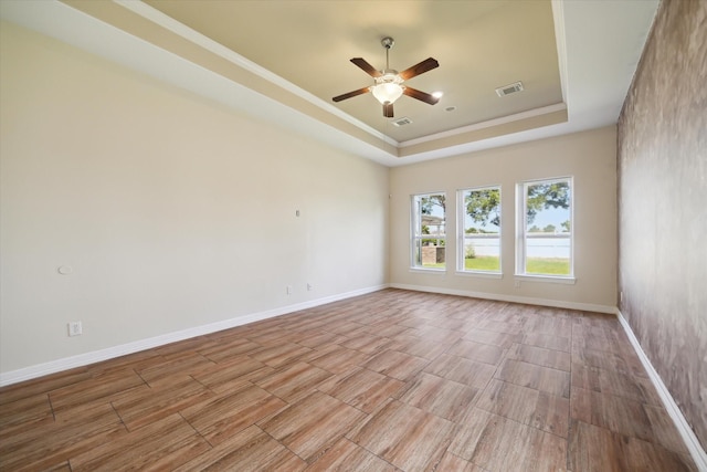 11127 Salento Ct, Richmond, TX 77406 - unfurnished room with a tray ceiling, ceiling fan, light wood-style floors, baseboards, and crown molding