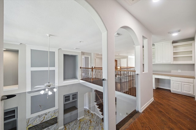 11127 Salento Ct, Richmond, TX 77406 - corridor with hardwood / wood-style floors, an upstairs landing, baseboards, and arched walkways