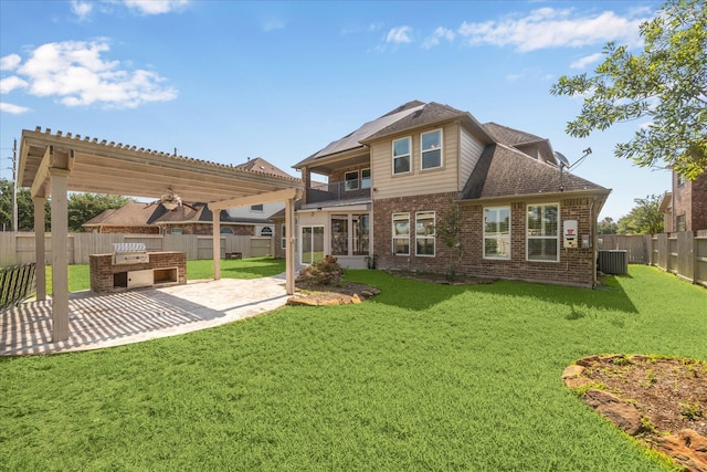 11127 Salento Ct, Richmond, TX 77406 - back of property with a balcony, brick siding, exterior kitchen, a patio area, and a shingled roof