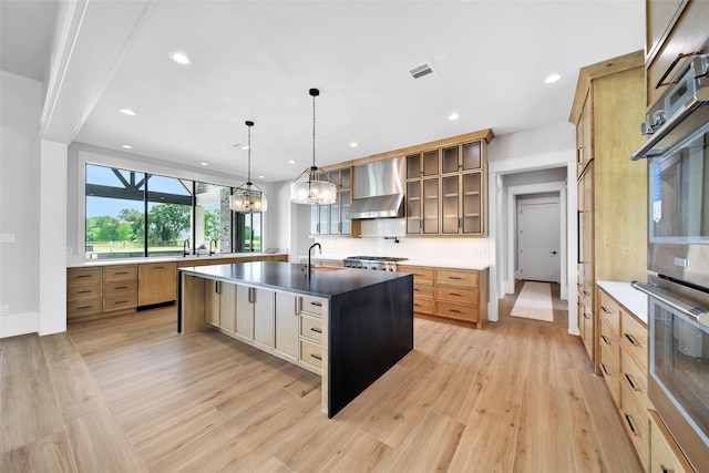 18829 Cypress Church Rd, Cypress, TX 77433 - kitchen featuring wall chimney exhaust hood, light wood-style flooring, paneled dishwasher, double oven, and a chandelier