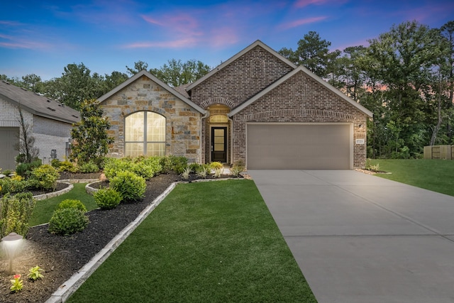 17723 Sapphire Pines Dr, New Caney, TX 77357 - french country style house featuring a garage, driveway, a lawn, stone siding, and brick siding