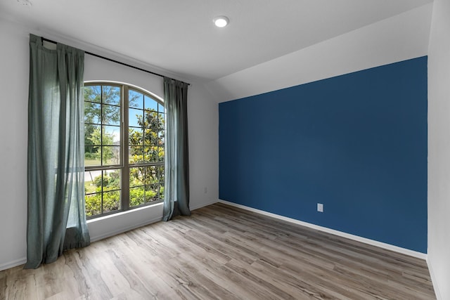 17723 Sapphire Pines Dr, New Caney, TX 77357 - empty room featuring lofted ceiling, wood finished floors, and baseboards