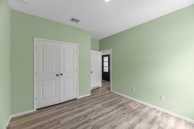 17723 Sapphire Pines Dr, New Caney, TX 77357 - unfurnished bedroom featuring wood finished floors, baseboards, and a closet