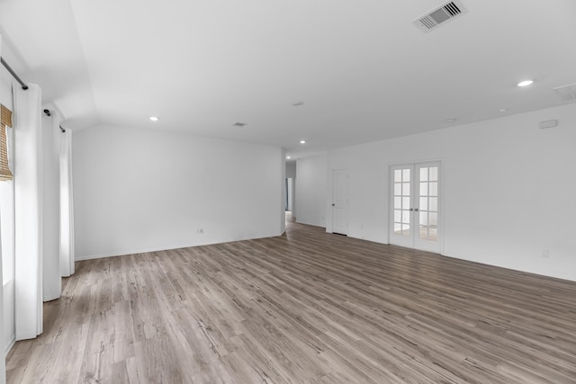 17723 Sapphire Pines Dr, New Caney, TX 77357 - unfurnished living room featuring light wood-style floors, recessed lighting, and french doors