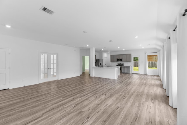 17723 Sapphire Pines Dr, New Caney, TX 77357 - unfurnished living room featuring french doors, light wood finished floors, and recessed lighting