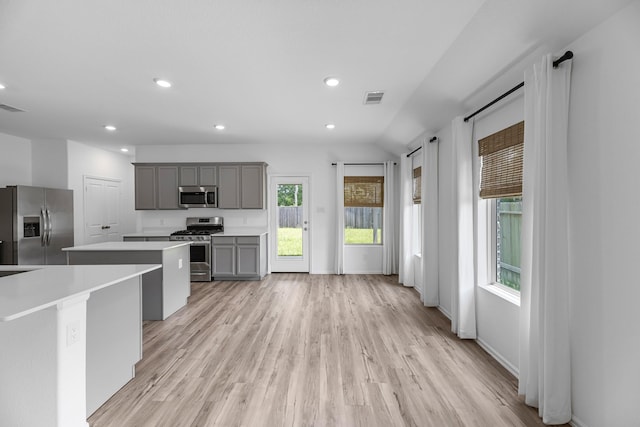 17723 Sapphire Pines Dr, New Caney, TX 77357 - kitchen featuring appliances with stainless steel finishes, gray cabinetry, a kitchen island, light countertops, and recessed lighting