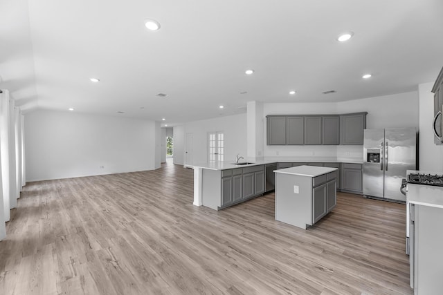 17723 Sapphire Pines Dr, New Caney, TX 77357 - kitchen featuring gray cabinets, appliances with stainless steel finishes, a sink, a kitchen island, and open floor plan