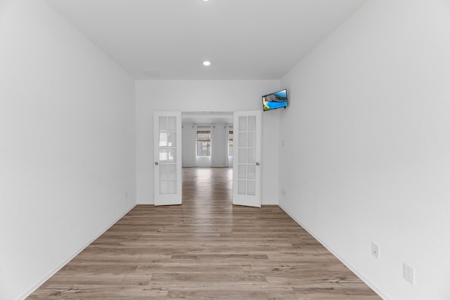 17723 Sapphire Pines Dr, New Caney, TX 77357 - empty room with french doors, light wood finished floors, recessed lighting, and baseboards