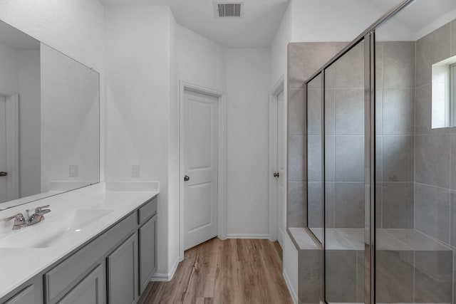 17723 Sapphire Pines Dr, New Caney, TX 77357 - bathroom featuring wood finished floors, a shower stall, and vanity