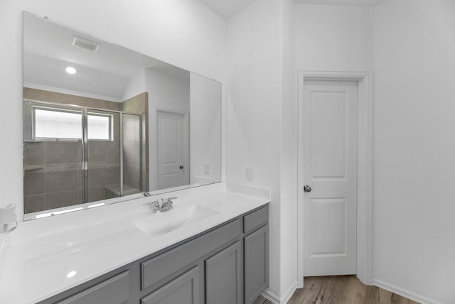 17723 Sapphire Pines Dr, New Caney, TX 77357 - bathroom with a stall shower, wood finished floors, vanity, and baseboards